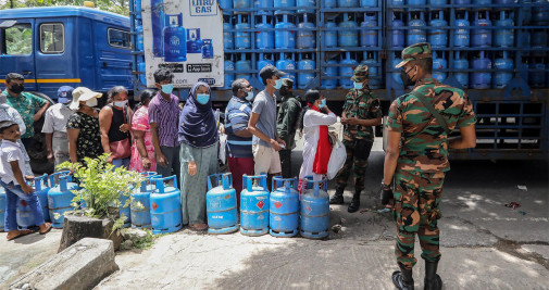Personal militar armado de Sri Lanka monta guardia mientras la gente hace cola para comprar cilindros de gas para cocinar, en medio de una escasez de gas - EFE/EPA/CHAMILA KARUNARATHNE