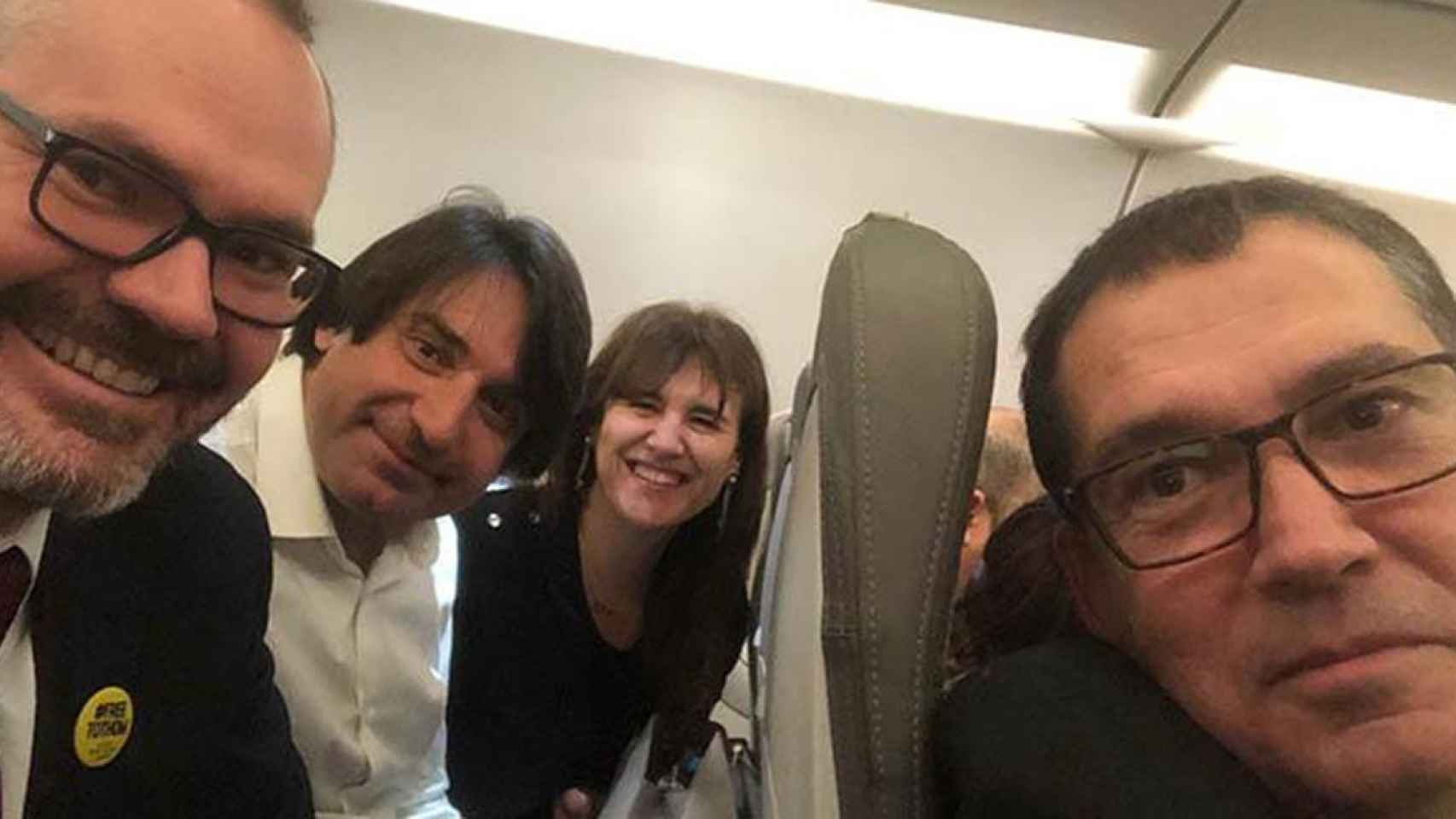 Los independentistas Josep Costa (i), Francesc de Dalmases, Laura Borràs y Jaume Alonso-Cuevillas (d) en el avión de regreso de Bruselas, a donde acudieron a escuchar la conferencia de Quim Torra y Carles Puigdemont / TWITTER