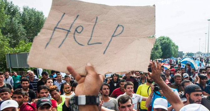 Entre los refugiados sobresale un cartel pidiendo ayuda / EFE