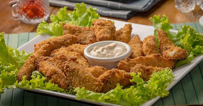 Plato de pollo rebozado para comer con las manos y chuparse los dedos / UNPLASH