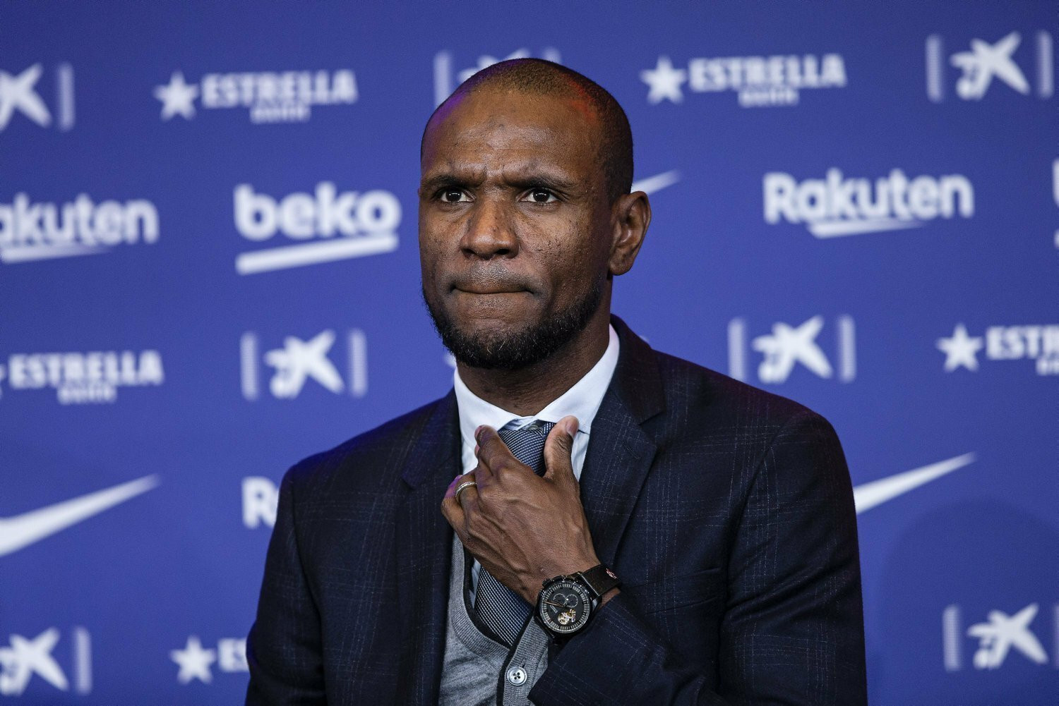 Abidal ajustándose la corbata antes de una rueda de prensa / EFE