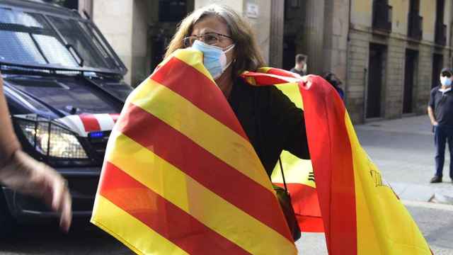 Una mujer sostiene una 'senyera' y una bandera de España / EUROPA PRESS