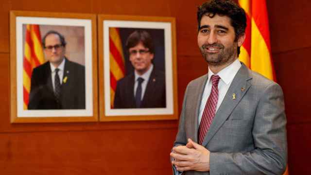 El vicepresidente de la Generalitat Jordi Puigneró (JxCat), junto a los retratos de Quim Torra y Carles Puigdemont / EFE
