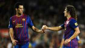 Sergio Busquets, junto a Carles Puyol | EFE