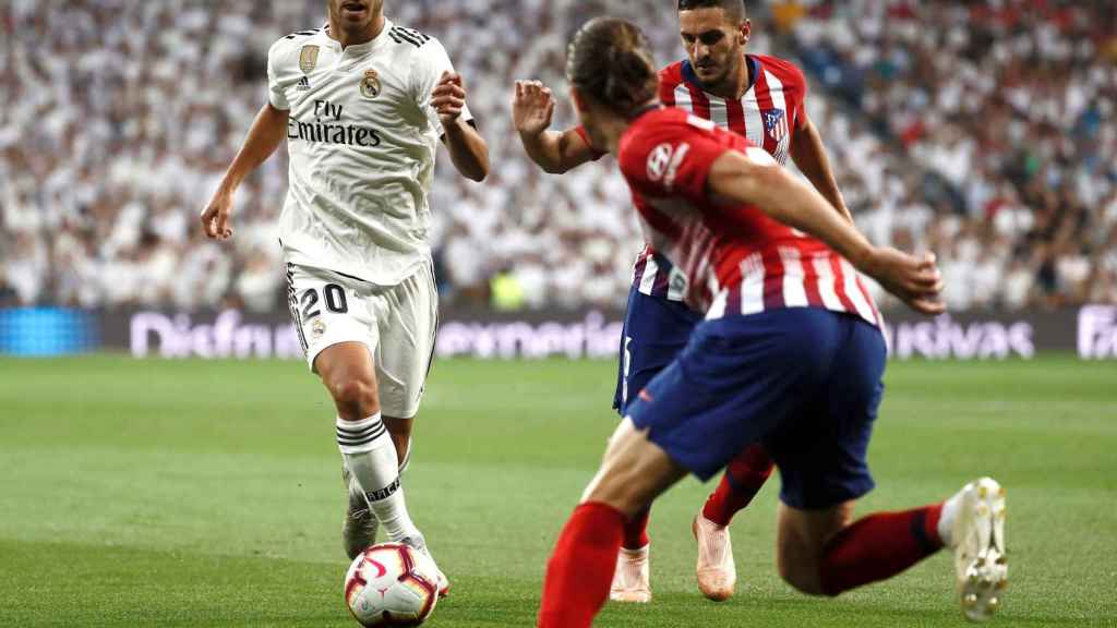 Marco Asensio conduce el balón durante el Real Madrid-Atlético / EFE