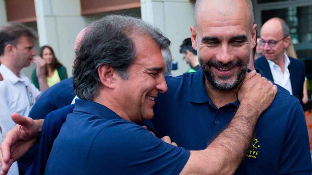 Joan Laporta y Pep Guardiola se abrazan en un acto de la Cruyff Foundation / EFE