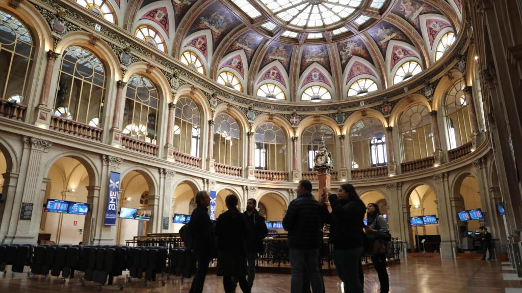 Un grupo de personas observa la evolución del Ibex en la Bolsa de Madrid / EP
