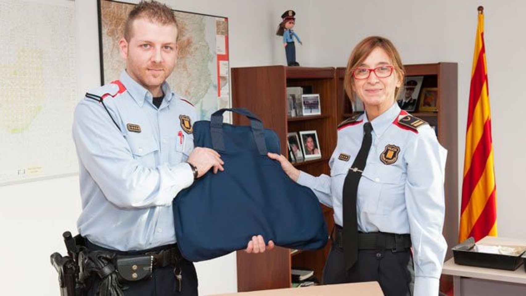 Agentes de los Mossos d'Esquadra sostienen un chaleco antibalas.