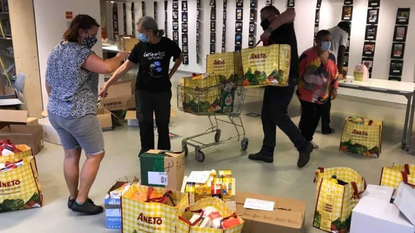 Miembros de la Xarxa de Suport Mutu Clot Camp de l'Arpa durante un reparto de alimentos contra la pobreza en Barcelona / EP