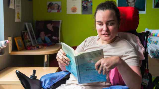 Una persona con discapacidad intelectual con un libro en lectura fácil / DINCAT (RESIDENCIA ESCLAT MARINA)