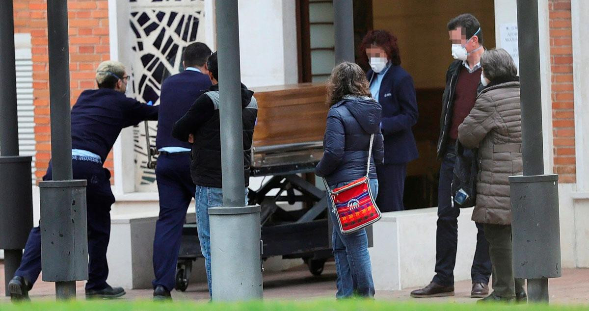 Operarios de la funeraria de Madrid conducen un féretro