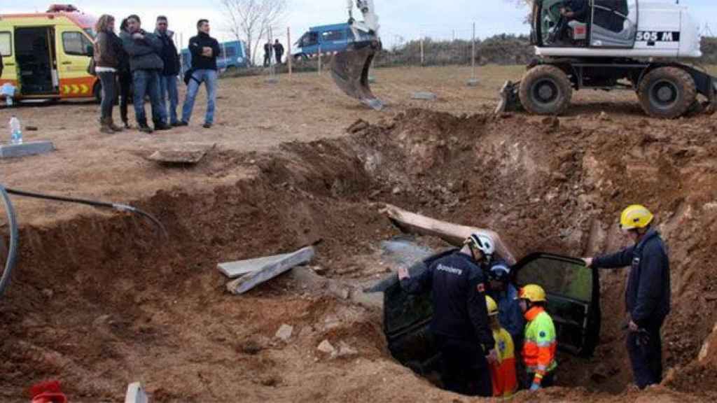 Los bomberos tratan de desenterrar el coche que los activistas habían cubierto de tierra donde iba una torre de la MAT en enero de 2014 / TWITTER