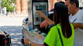 Una agente del área verde de Barcelona, ayudando a un conductor / CG