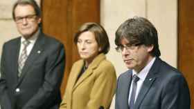 El presidente de la Generalitat, Carles Puigdemont, ante el expresidente Artur Mas, y la presidenta del Parlament, Carme Forcadell.