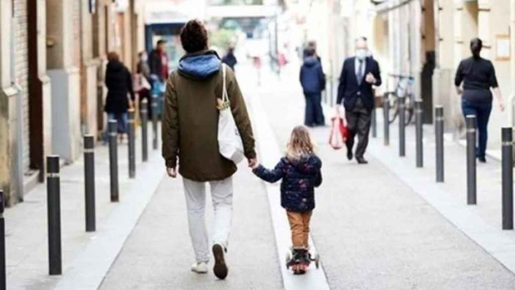 Una niña pasea por la calle / EFE