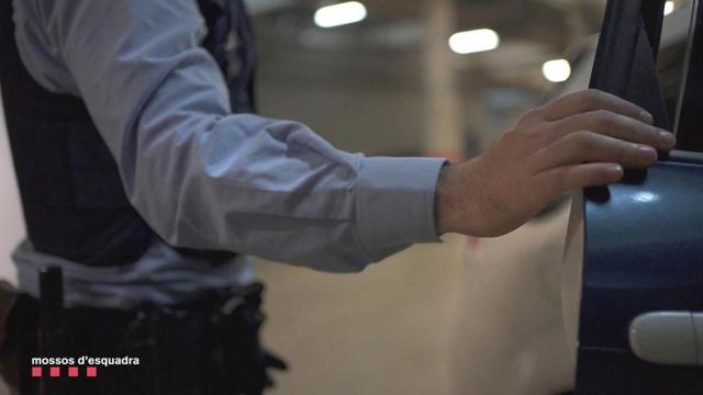 Un agente de los Mossos d'Esquadra junto al coche patrulla / MOSSOS