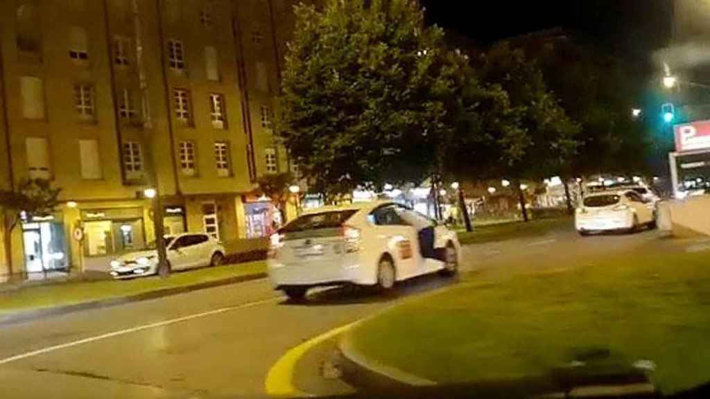 Un hombre cuelga de la ventanilla de un taxi en Gijón / CG