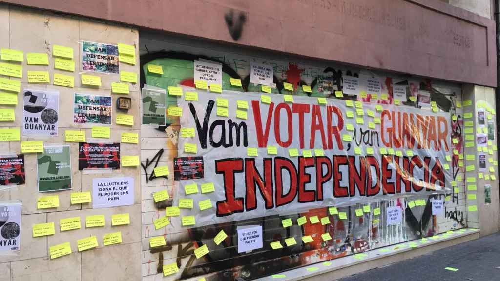 La sede de la CUP con la persiana bajada y tapada por el mural de los CDR / CG