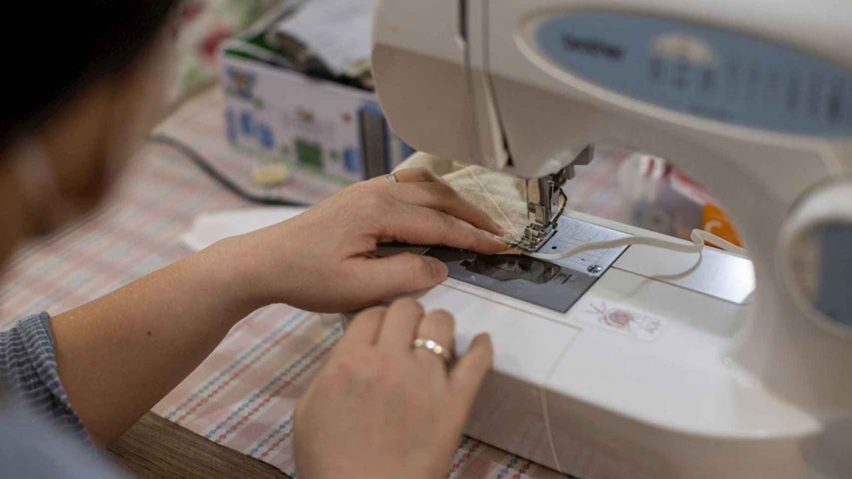 Una mujer teje mascarillas / EFE