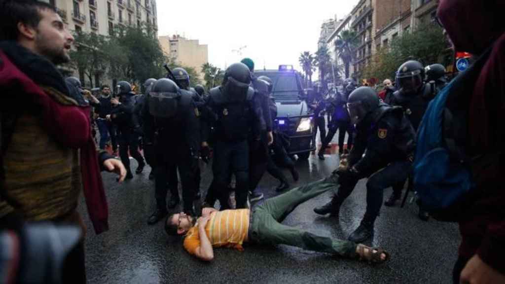 Imagen de una de las cargas policiales del 1 de octubre, con un herido en el suelo. Un médico dice que contaron como heridos hasta las crisis de ansiedad / EFE