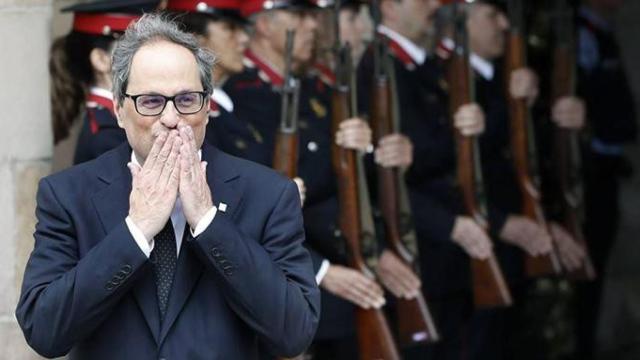 El presidente Quim Torra lanza besos con los Mossos d'Esquadra formando en segundo plano / EFE