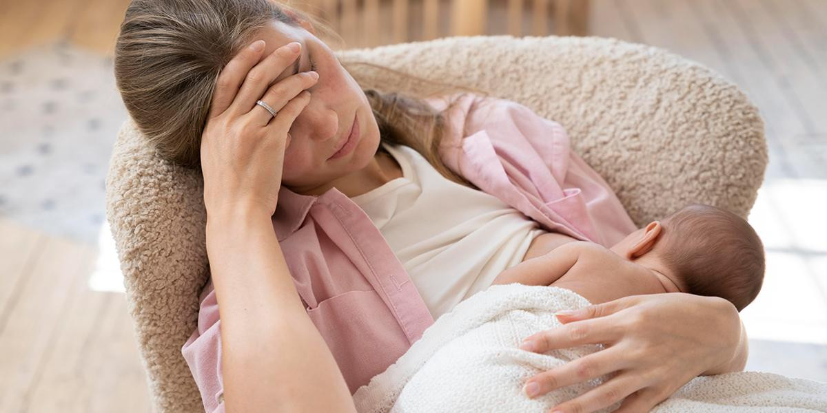 Una madre cansada da el pecho a su bebé / FREEPIK