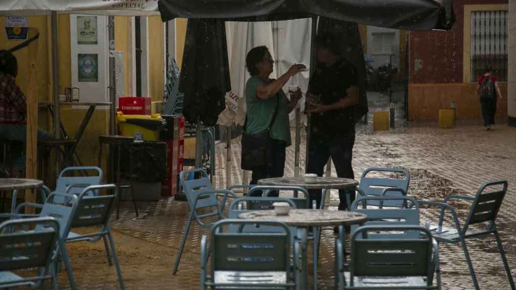 Clientes de un bar se protegen de la lluvia / EUROPA PRESS