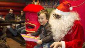 Papá Noel con un niño en sus piernas / EUROPA PRESS