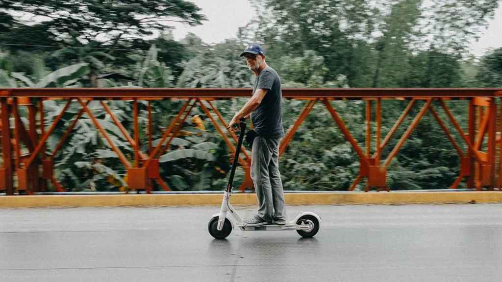 Un hombre desplazándose con un patinete eléctrico / PEXELS