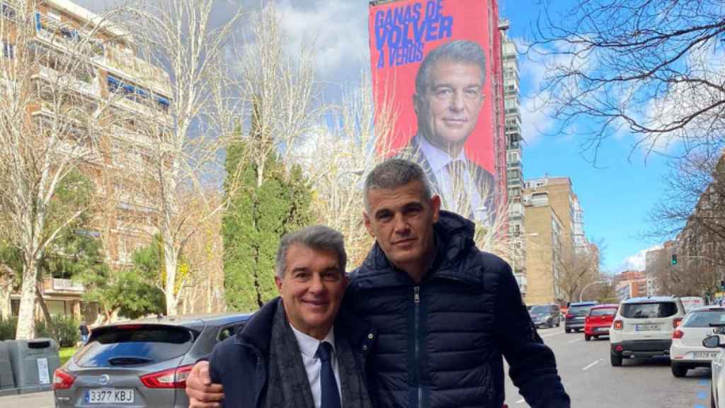 Joan Laporta y Enric Masip posan cerca de la lona publicitaria que colocó el presidente del Barça en Madrid / EFE