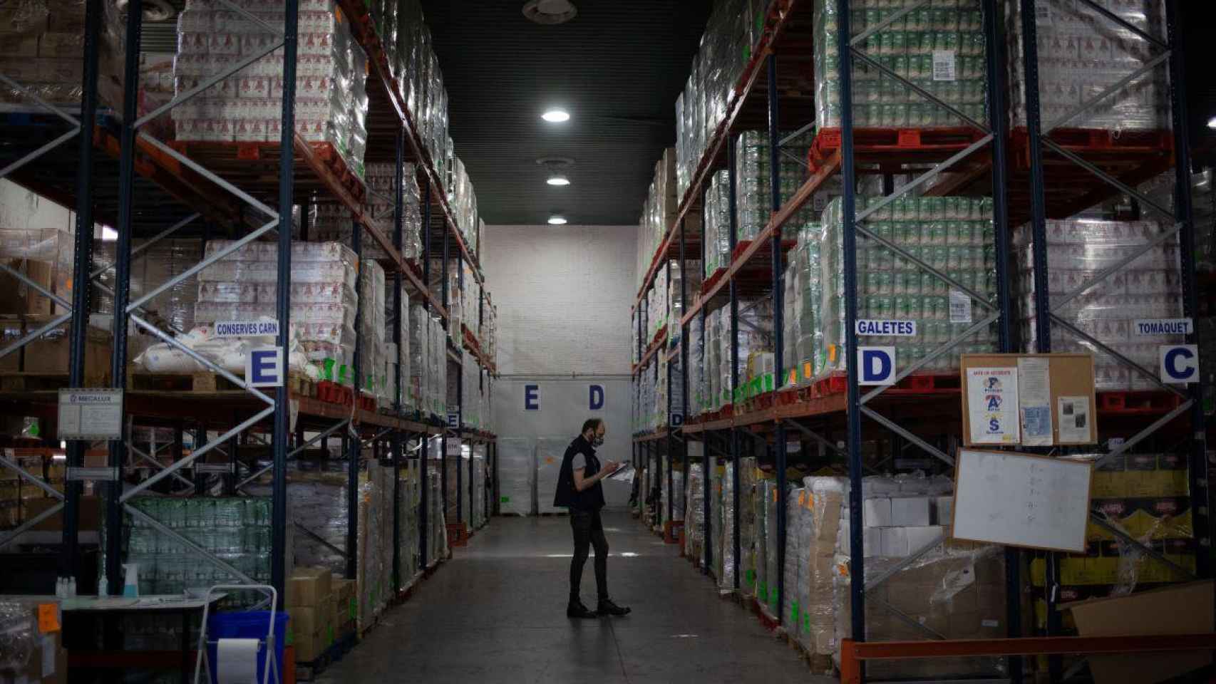 Un trabajador realiza un registro en el Banco de Alimentos de Barcelona / EP