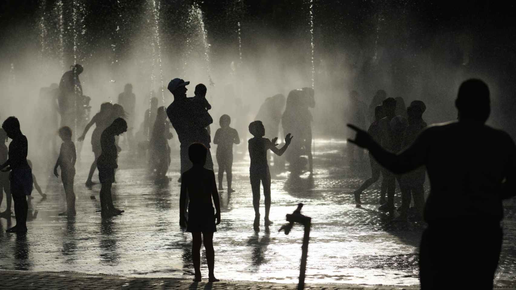 Varias personas se refrescan en una fuente durante la ola de calor / FERNANDO SÁNCHEZ - EUROPA PRESS