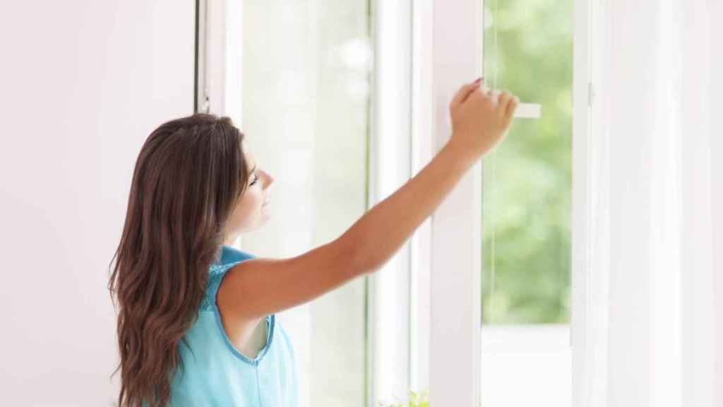 Una mujer frente a una ventana