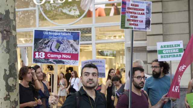 Varios manifestantes alzan sus pancartas en contra de la alianza del Barça con Limak