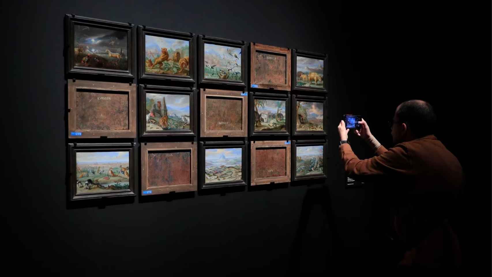 Una persona toma fotografías de algunas de las obras expuestas por delante y por detrás en la exposición ‘Reversos’ del Museo del Prado.