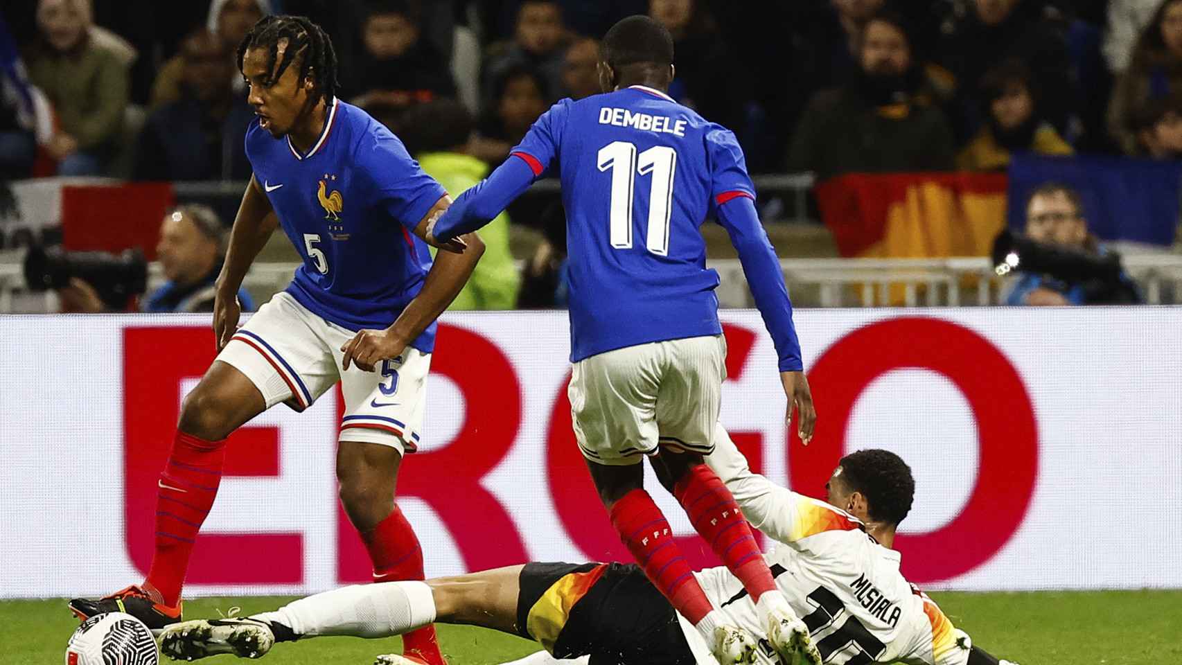 Jules Koundé protege el balón ante la marca de Musiala en el Francia-Alemania