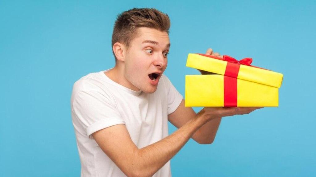 Hombre sorprendido abriendo un regalo