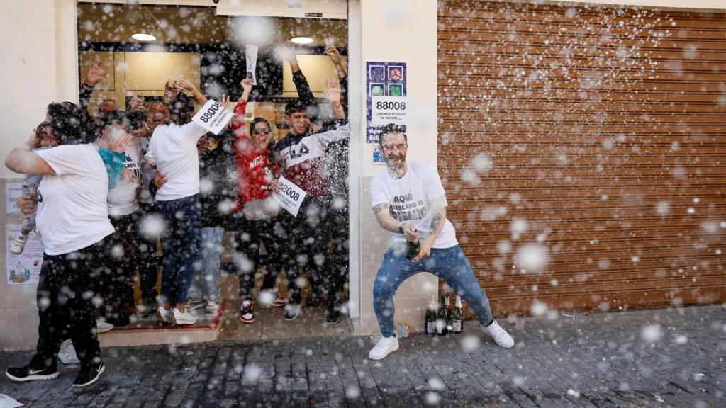 Varias personas celebran que les ha tocado la Lotería de Navidad