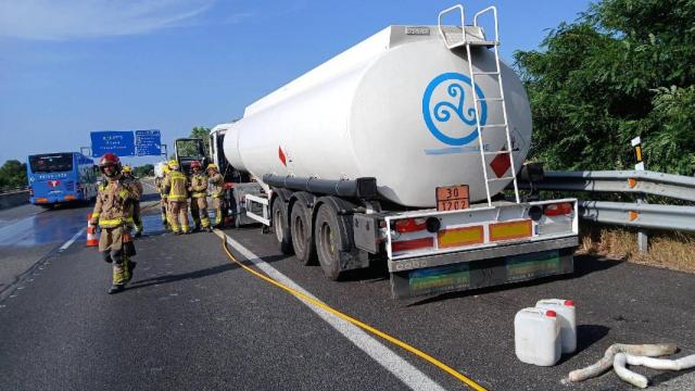 Los Bombers de la Generalitat trabajan en el incendio de un camión cistena en la AP-7, el 11 de junio