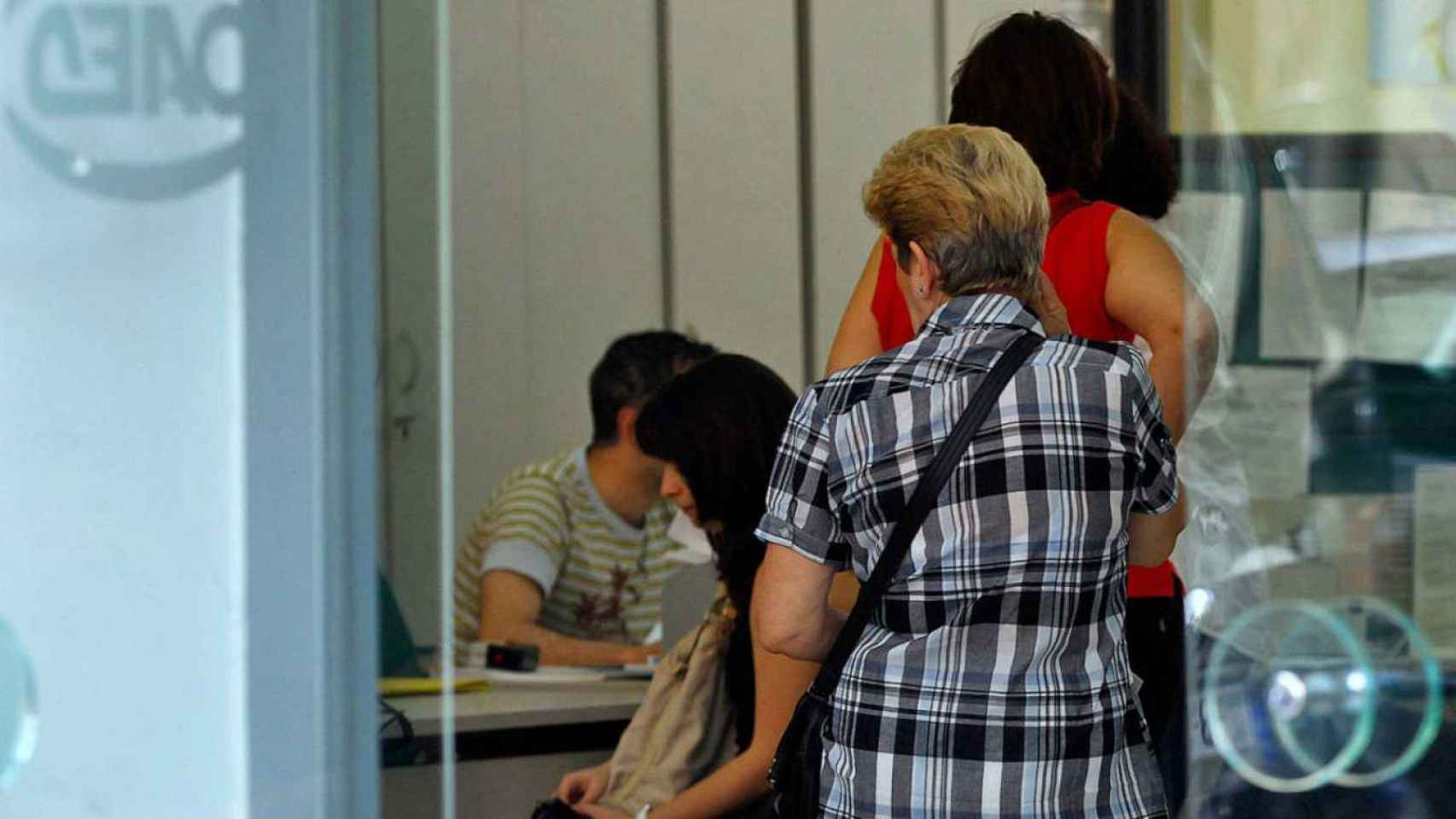 Mujeres en la entrada de una oficina del paro. / EFE