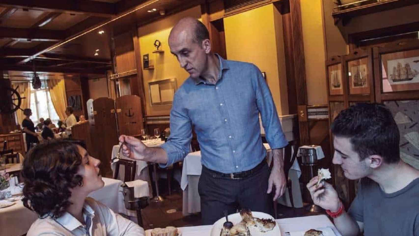 Aitor Arregi, con un par de clientes en el restaurante Elkano.