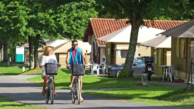 Una pareja disfruta de un paseo en bicicleta dentro del camping.