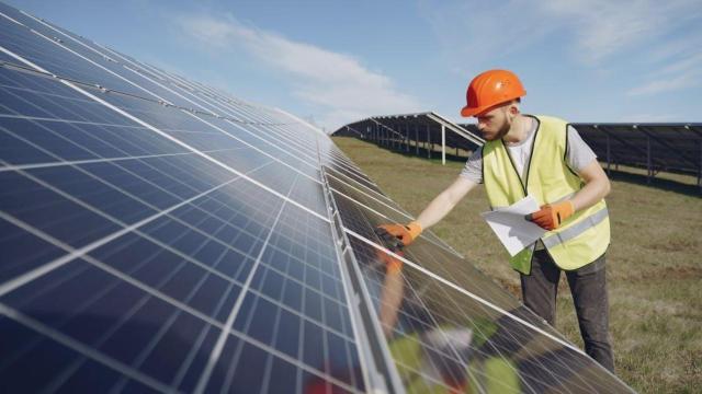 Trabajador junto a un parque fotovoltaico