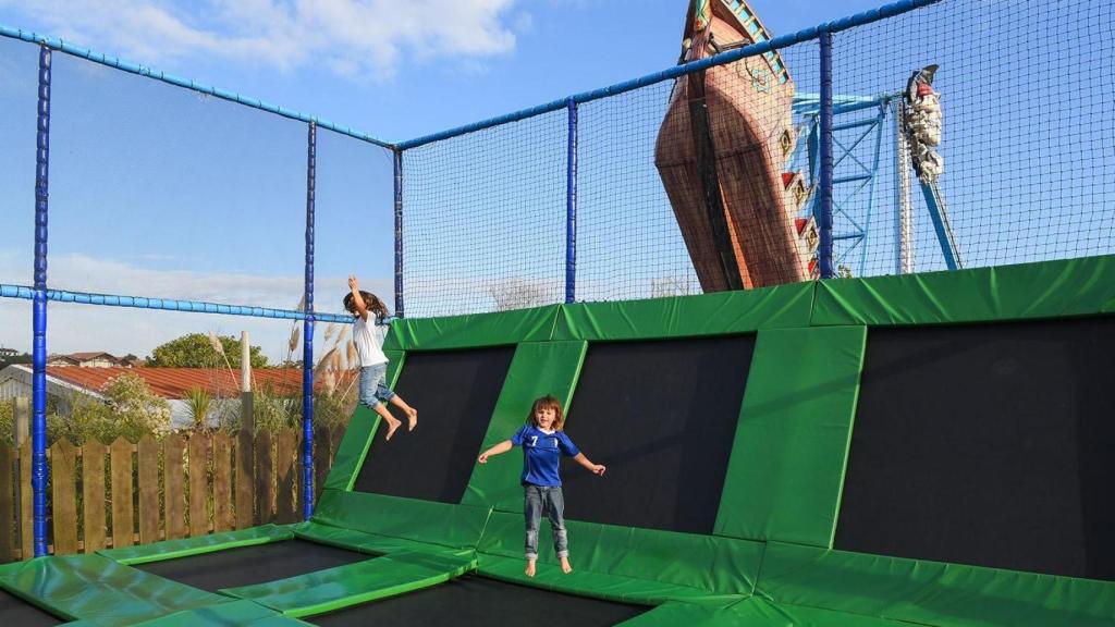 Unos niños disfrutan de las camas elásticas del parque.