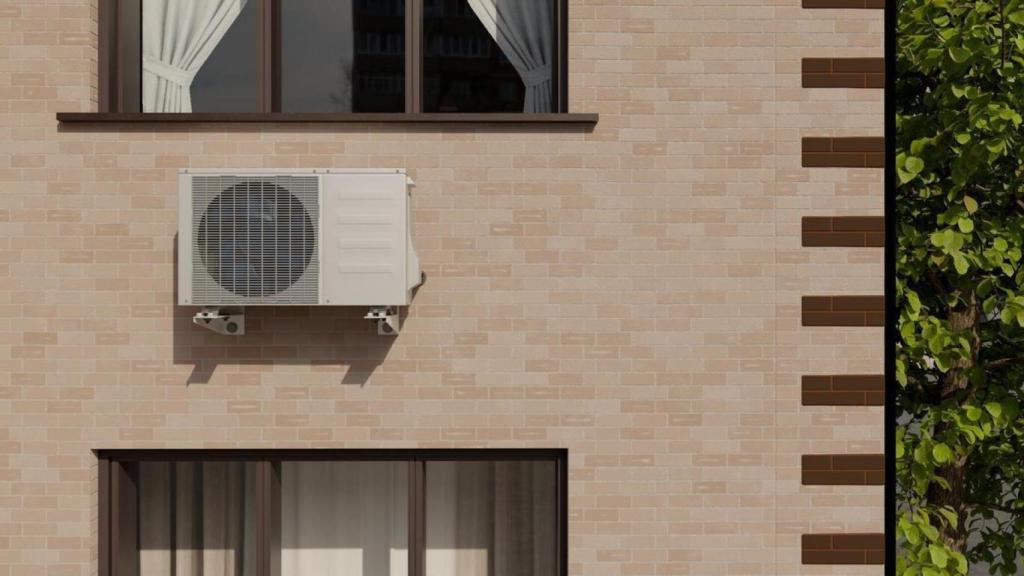 La unidad exterior de un aparato de aire acondicionado, instalada en la fachada de una casa. / Freepik