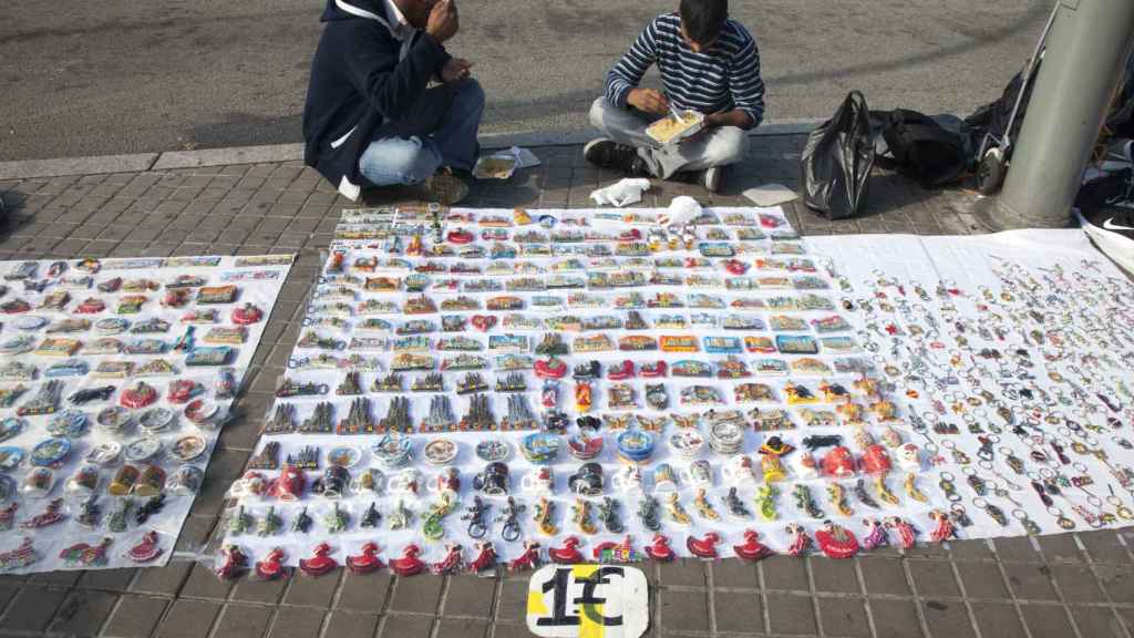 Vendedores del Top Manta comiendo en plena calle / HUGO FERNÁNDEZ