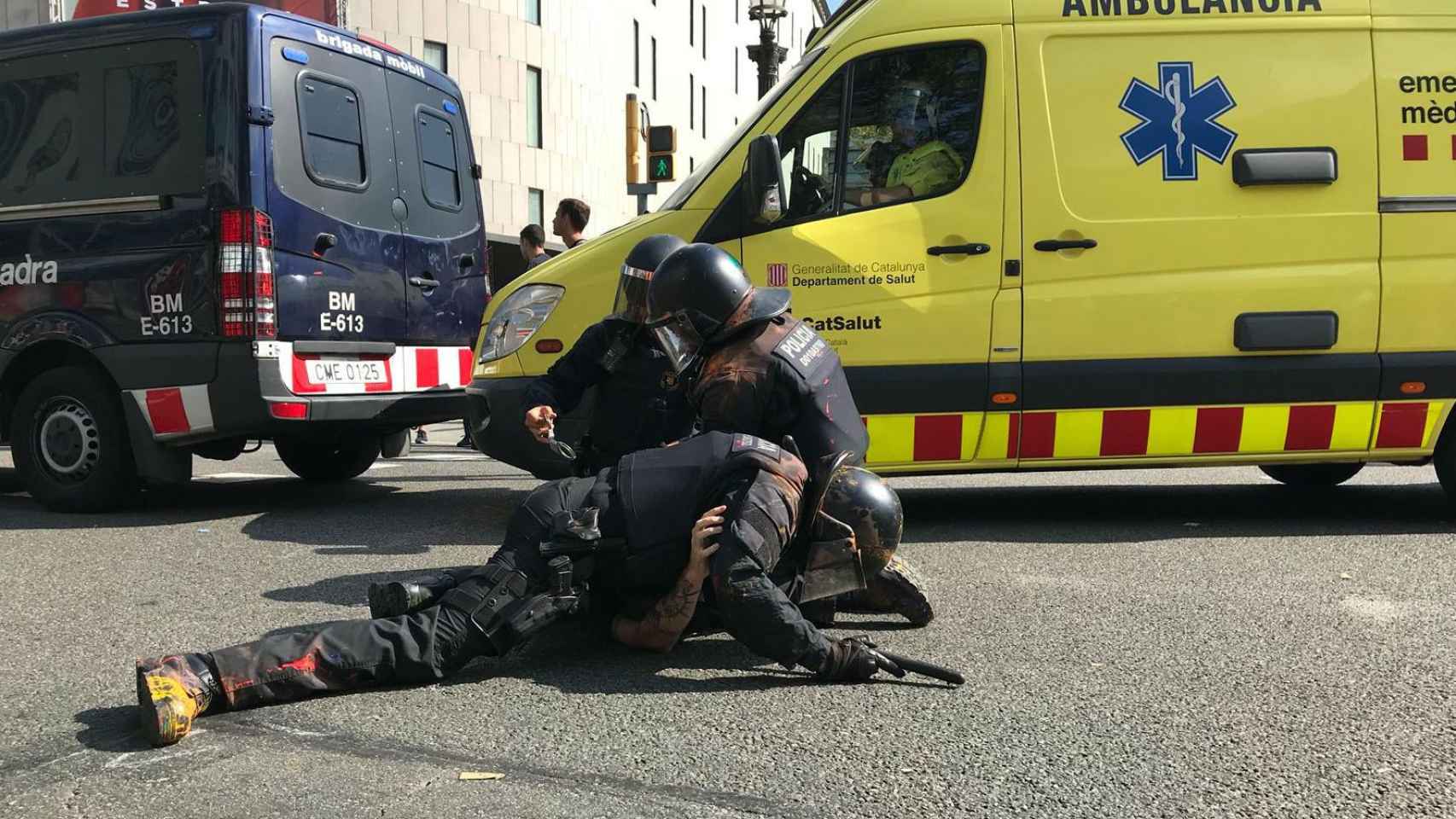 Unos mossos reducen a un manifestante en la plaza de Catalunya / LETICIA FUENTES