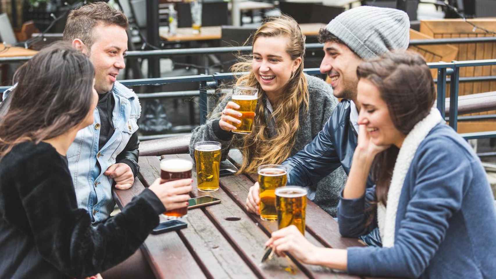 Grupo de amigos tomando algo y haciendo intercambio de idiomas / SHUTTERSTOCK