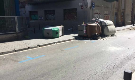 Contenedores volcados para evitar el acceso de la policía al edificio