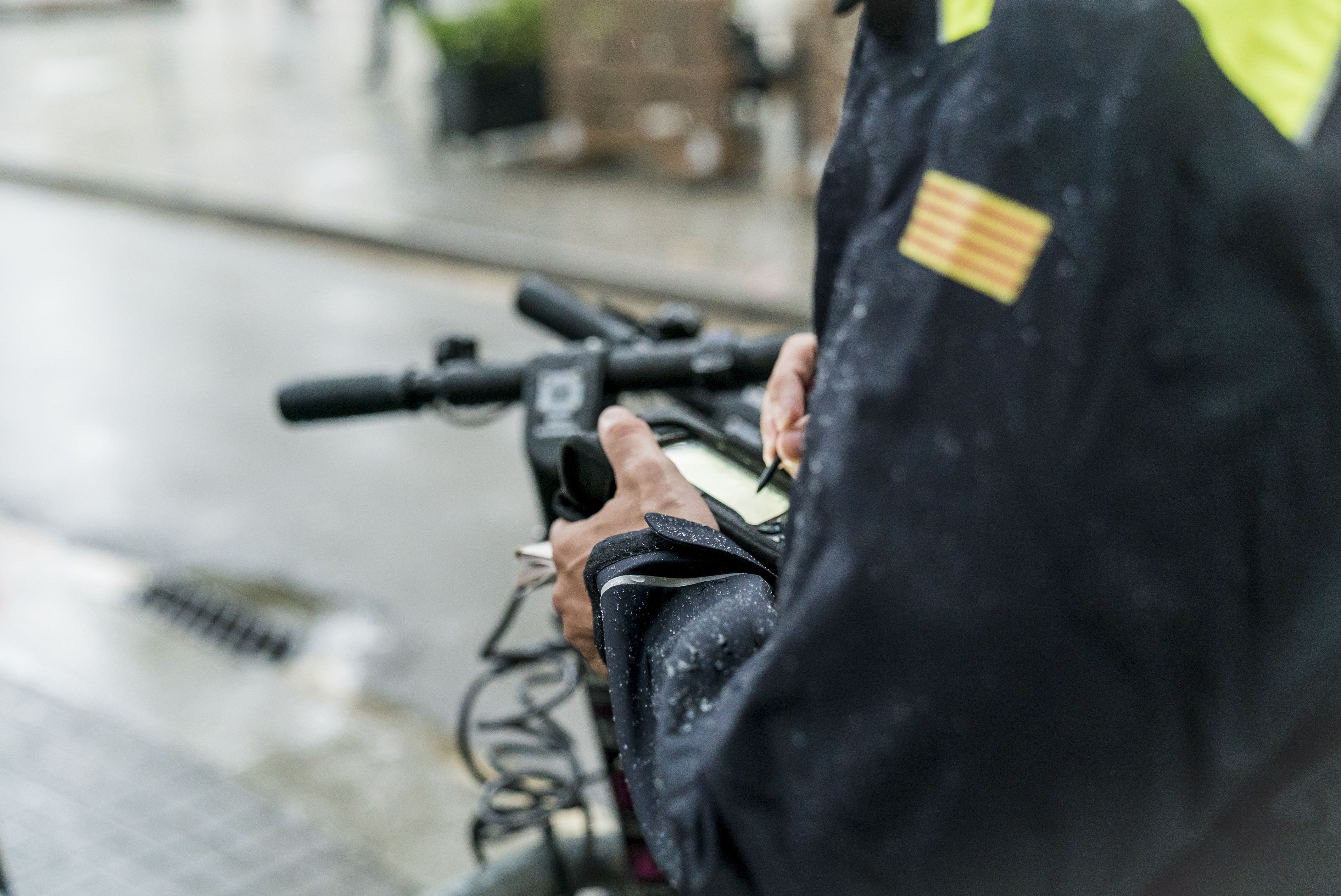 Un guardia urbano deposita una multa en un patinete / AYUNTAMIENTO DE BARCELONA